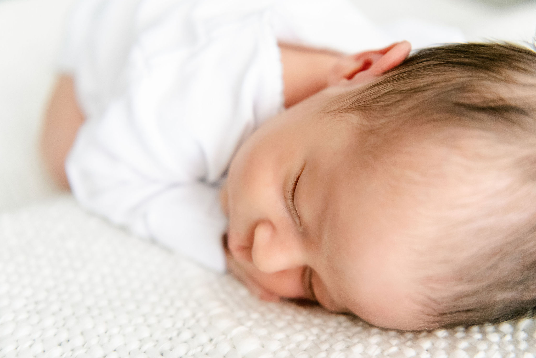 newborn baby sleeps in white shirt tampa doula